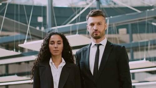 Corporate Professionals Stand Confidently in a Modern Office Environment