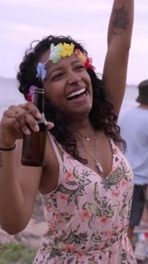 Happy African American Woman Dancing in Front of the Camera at the Beach