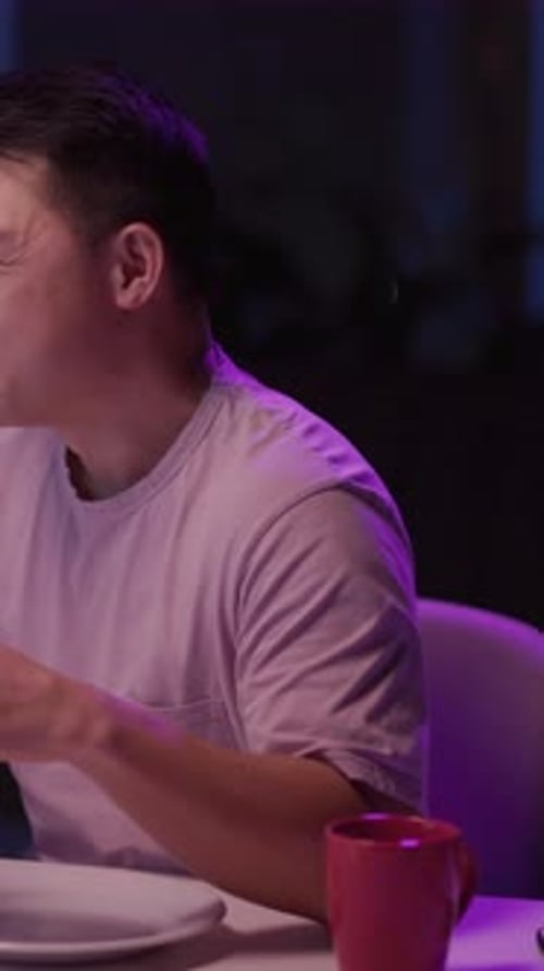 A Man Relaxes at a Cozy Cafe Enjoying a Croissant and Coffee