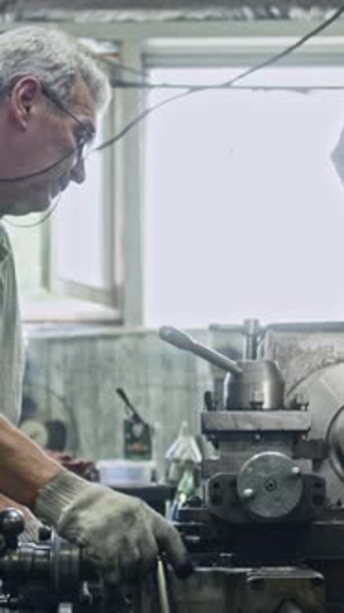 Skilled worker operating heavy machinery in workshop