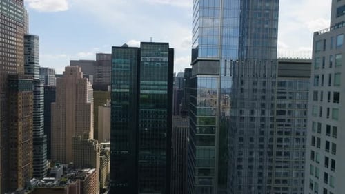 Drone flying in middle of high-rise in Midtown, Manhattan, summer day in New York