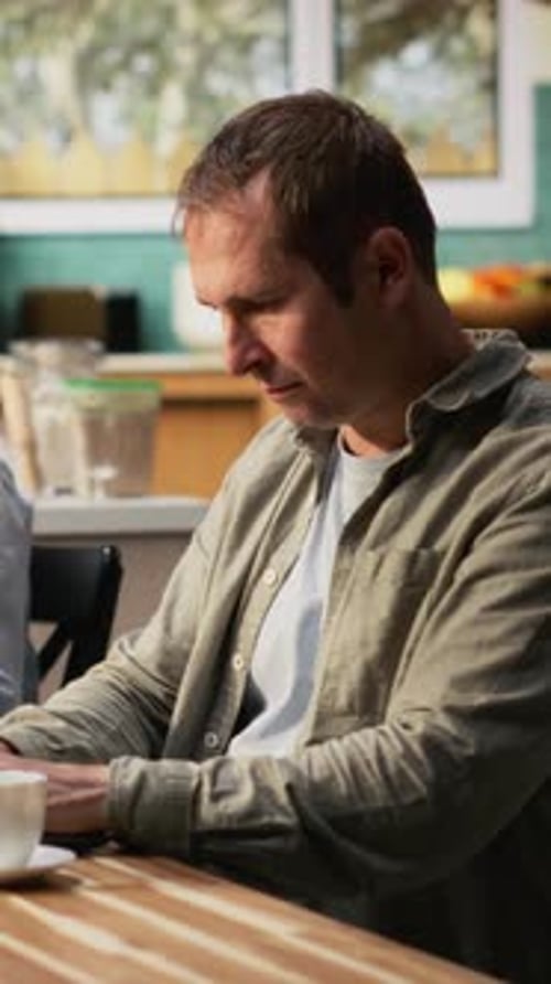 Vertical Video Busy Father Ignoring His Daughter at Breakfast Table and Focusing on Work