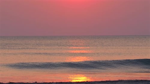 Ocean Waves at Sunrise on Sandy Beach