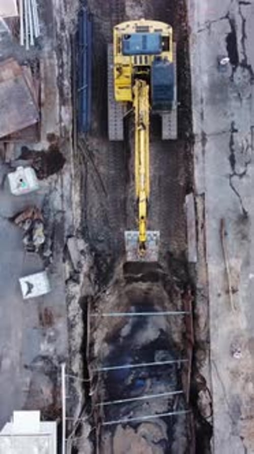 Aerial View of Excavator Digging a Trench