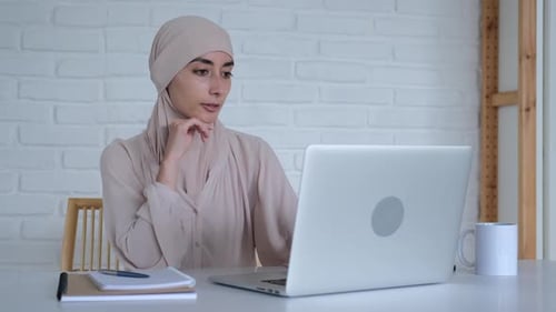 Woman in Headscarf Working on Laptop Indoors