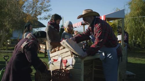 People Buying Produce at Farmers Market on Sunny Day