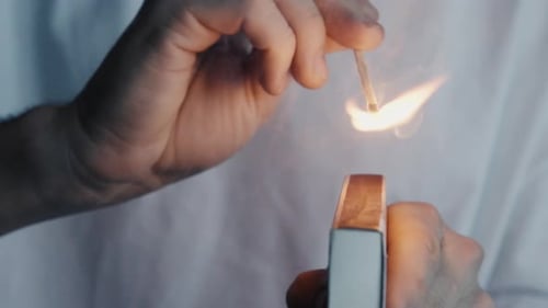 Hand Lighting a Match in Macro Detail