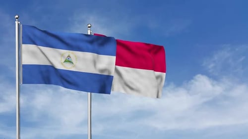 Waving Flags of Nicaragua and Indonesia Against Blue Sky