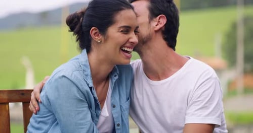 4k video footage of a young couple sharing a romantic moment on a park bench