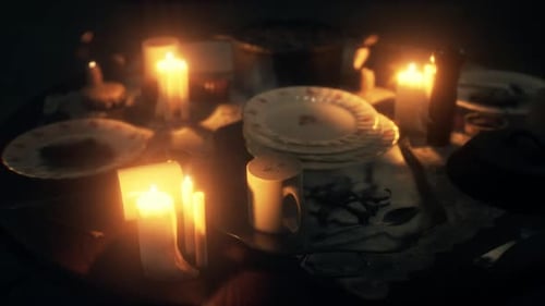 Warm Flickering Candlelight on Dinner Table