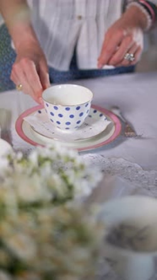 Setting Tea Table with China and Flowers