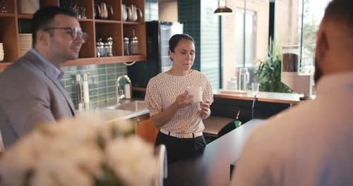 Business Colleagues Chatting Over Coffee at Modern Workplace
