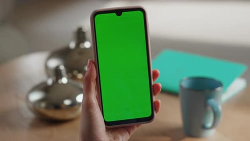 Lady Hands Scrolling Green Screen Mobile Phone Shopping Online at Home Closeup