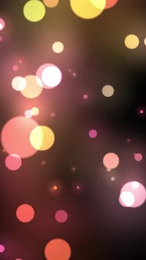 Blurred pink and yellow shimmering particles background.