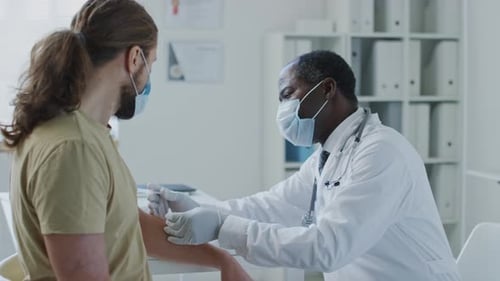 Doctor Gives Injection to Patient in Medical Clinic