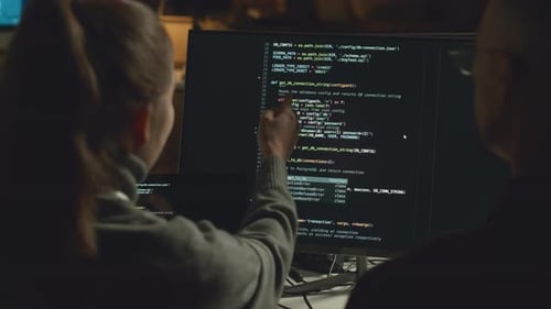 Programmers Coding on Computer at Night