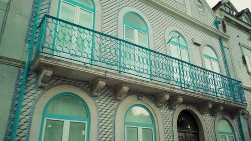 Lisbon ancient tile building facade with balcony in typical neighborhood with travel shot low angle