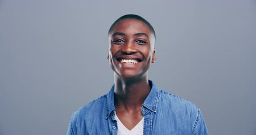 Young Adult Smiling and Making Heart Shape