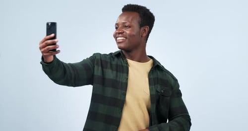 Happy black man, phone or video call wave on studio background for social media
