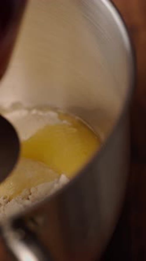 Mixing flour and egg in bowl close-up