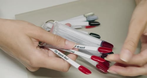 Woman Selecting Nail Polish Color at Salon