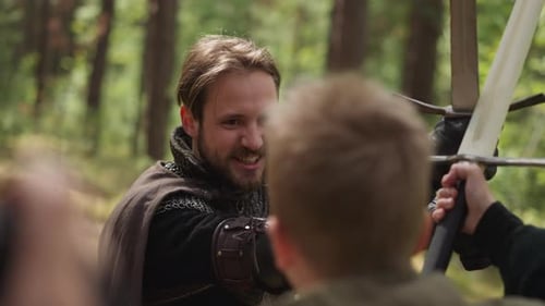 Man in Knight Armor Fights with Boy on Swords at Camp