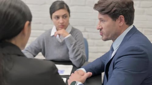 Side view of Businessman Talking with Mixed Race Teammates