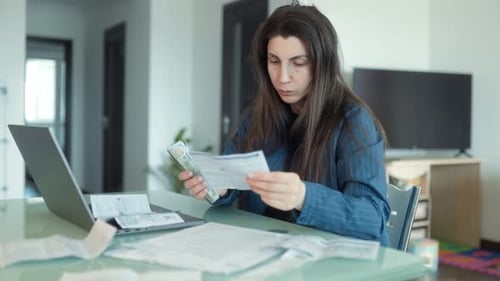 Woman Counts Money and Sorts Bills at Home