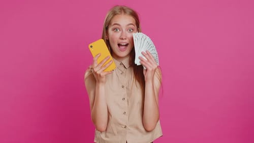 Excited Woman Holding Smartphone and Money