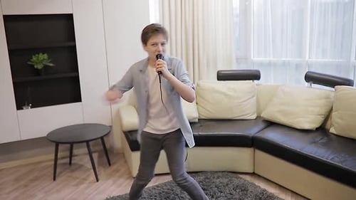 Enthusiastic Teen Singing and Dancing at Home