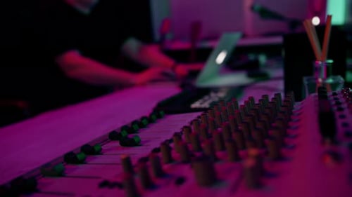 professional sound recording studio sound engineer or music producer sitting at the remote control