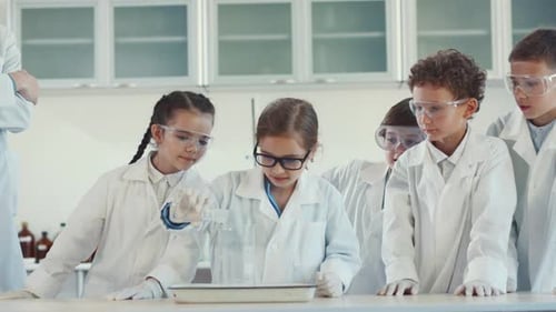 Excited Kids Do Science Experiment in Classroom