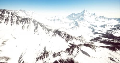 Aerial Flight Over Majestic Snowy Mountain Peaks