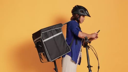 Woman Using Phone Next to Bicycle with Delivery Box