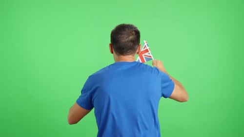 Rear View of a Man Waving a British Pennant