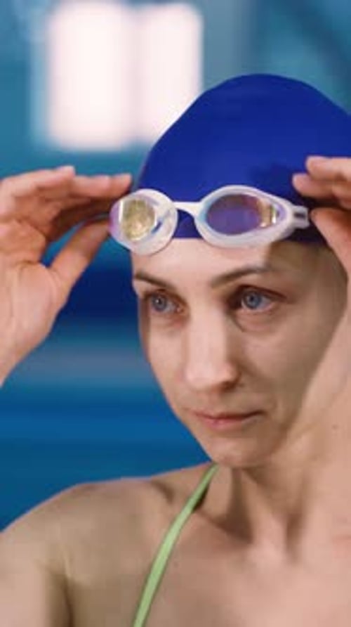A Young Woman Swimmer Warms Up Before Swimming in a Swimming Pool Young Motivated Focused Athlete
