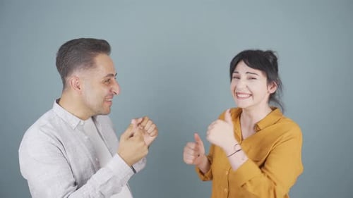 Couple rejoicing looking at camera.