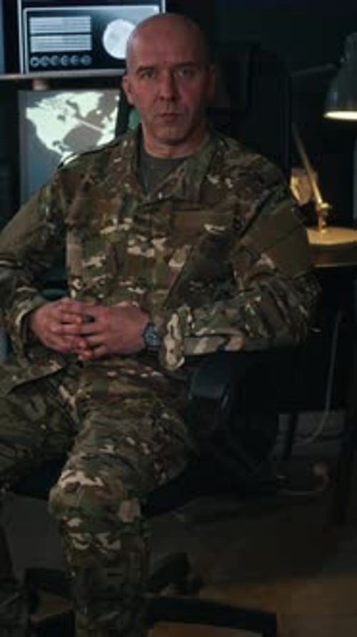 Commander in Camouflage Uniform Working at Central Hub