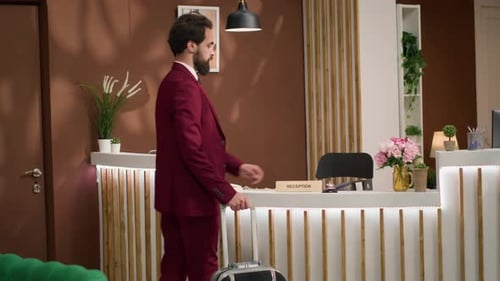 Guest Checking in at Hotel Reception Desk