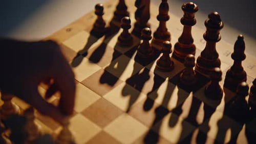 Hand Shifting Chess Pawn on Board Surface with Shadows Opponent Moving Item