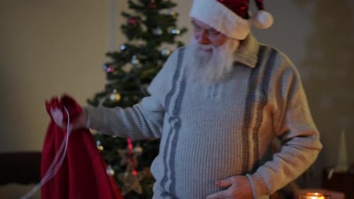 Stressed Man Dressed as Santa Sits Down