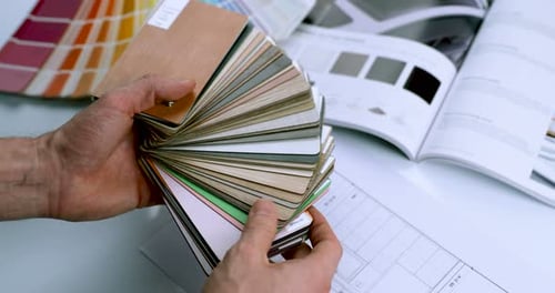 Hands Fanning out Color Swatches for Design