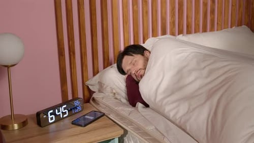 Man Waking Up and Reaching for his Phone