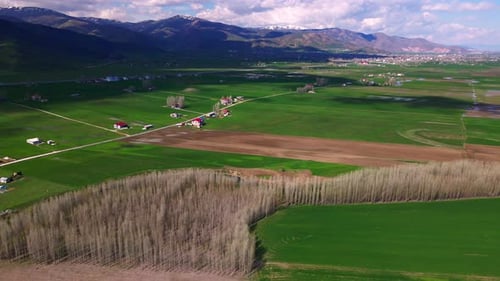 Aerial view of a wide, open plain with roads and streams running through it