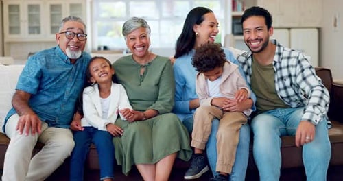 Happy Family Smiling on Couch Together