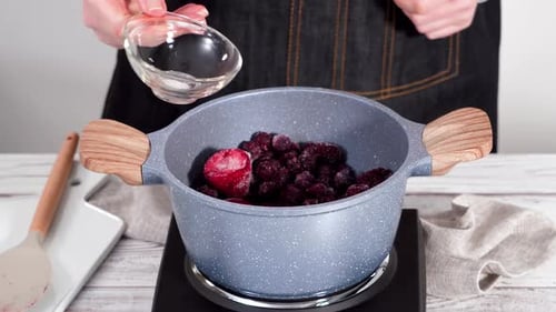 Making Fruit Compote With Berries, Syrup, and Water