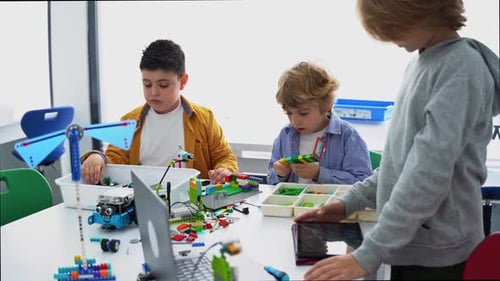 Boys Building Robots in School Classroom
