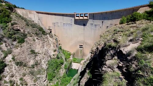 Vault dam inside a mountain canyon and river. Beznar Dam. Spain.