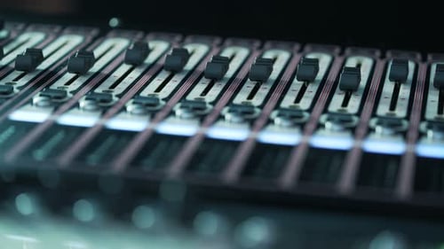 Audio Mixer in a Studio, the Automatic Knobs Moving Up and Down