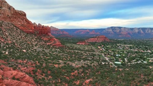 Remote Town Amidst Towering Sandstone Red Rock Canyons In Sedona, Arizona, United States. Aerial Dro